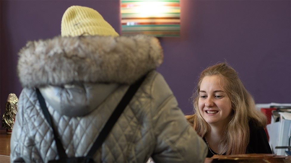 Young person being helped by worker at Streetlife charity