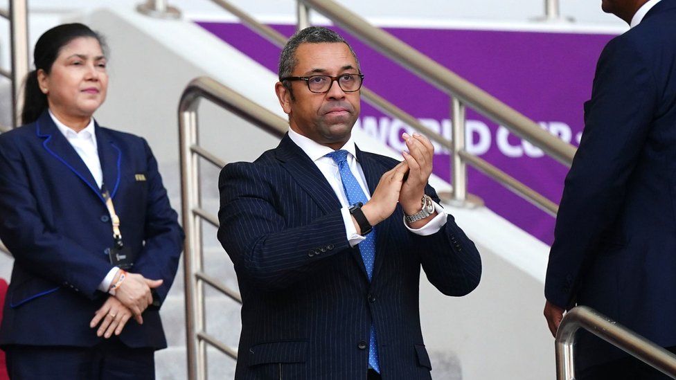 British Foreign Secretary James Cleverly applauds while attending a game at the 2022 World Cup in Qatar