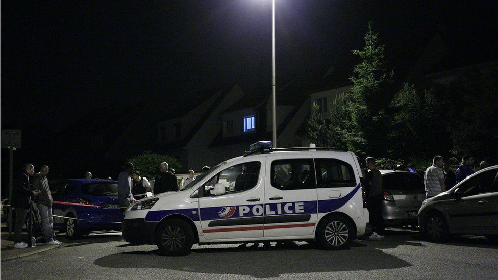 Police vehicle blocks the road during an assault in Magnanville, near Paris, on 14 June