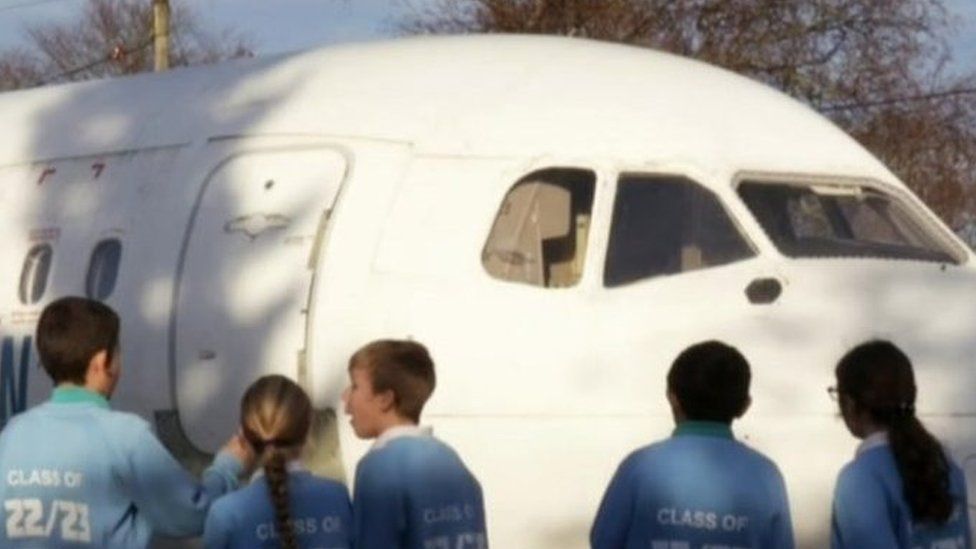 Pupils looking at the plane