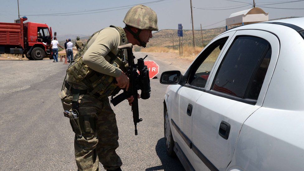 A Turkish solders check cars at a check point in Diyarbakir on July 26, 2015