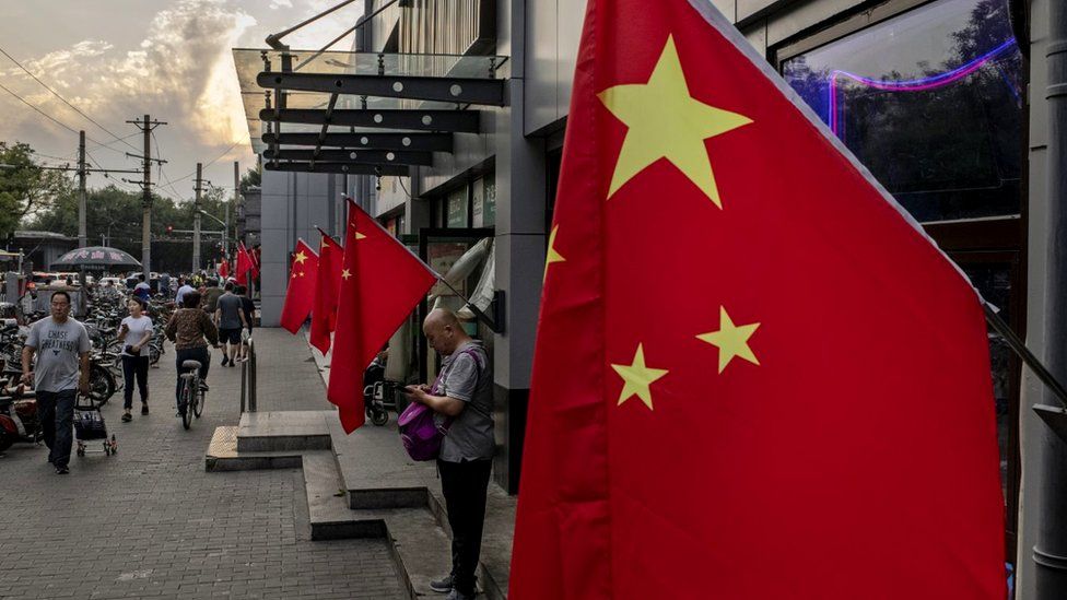Chinese flags outside a row of shops