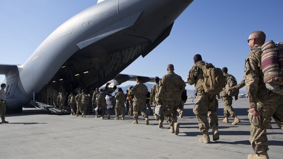US soldiers walk to their C-17 cargo plane for departure May 11, 2013 at Bagram Air Base, Afghanistan