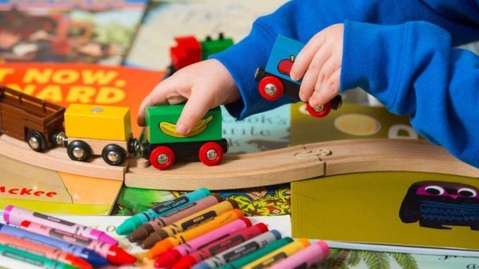 A child playing with a toy train