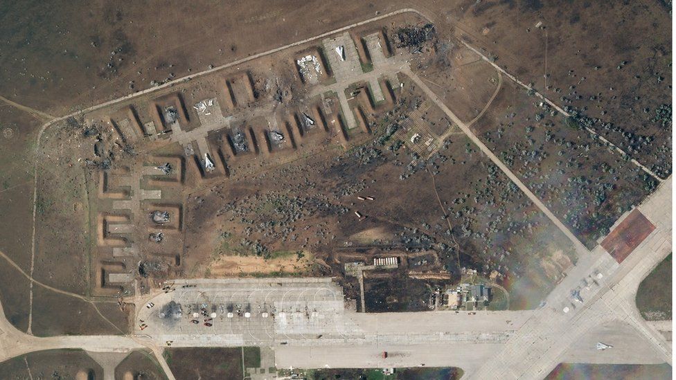 A satellite image showing damaged planes and scorched land.