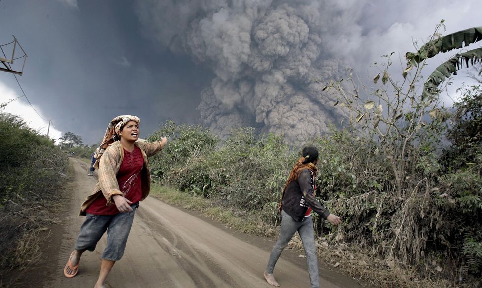 Villagers flee a volcano on Sumatra