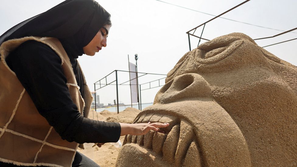 A student from Matrouh University making a sand King Kong sculpture, Alexandria, Egypt - Tuesday 9 May 2023