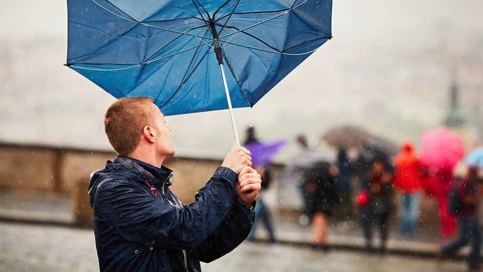 Man with a broken umbrella