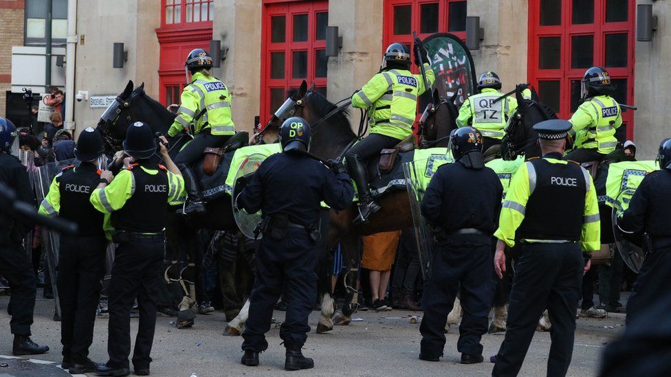 Police horses hold back protesters outside Bridewell Police Station as they take part in a "Kill the Bill" protest in Bristol