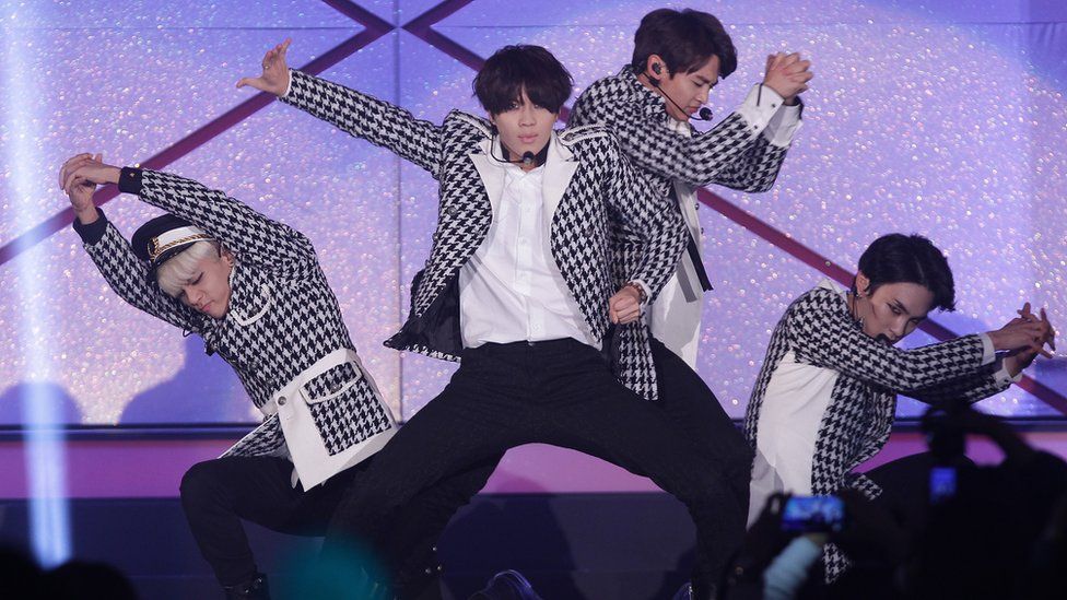 Korean pop band Shinee dancing on stage