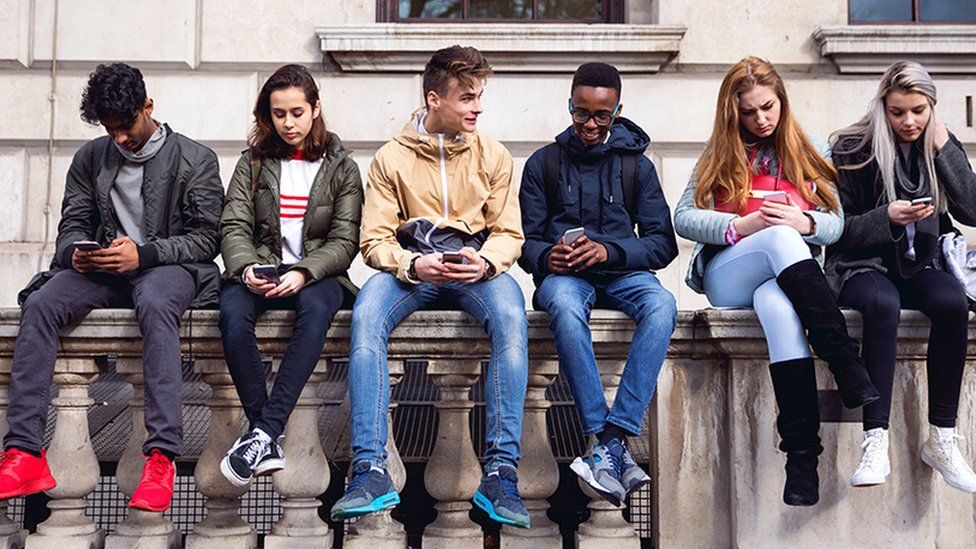 Young people on mobiles