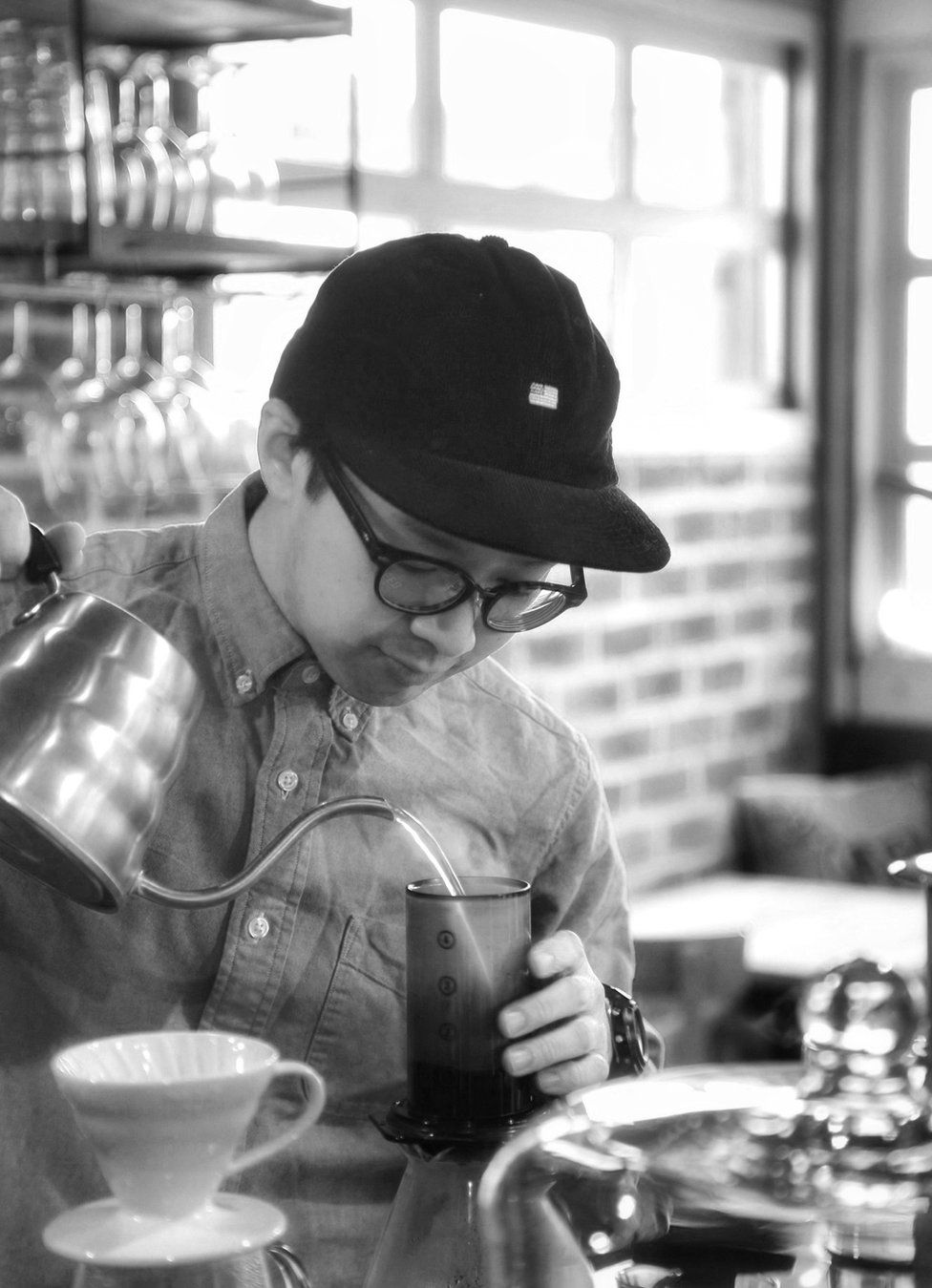 A barista pours a coffee