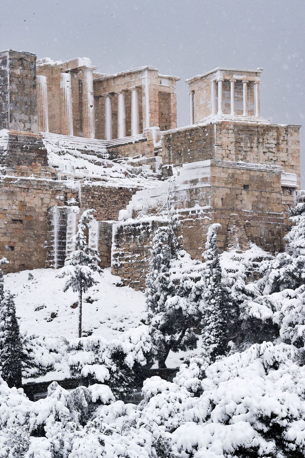 Snow falls on ancient ruins in Athens