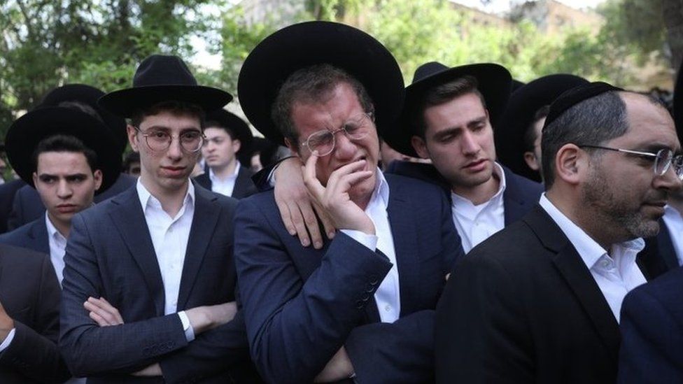 A man weeps at the funeral in Jerusalem of Avrohom Daniel Ambon, one of the 45 people killed in a crush at Lag B'Omer festival in northern Israel (3 May 2021)