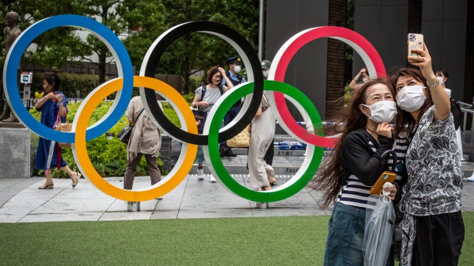 People take selfie with Olympics rings on July 27, 2021 in Tokyo, Japan.
