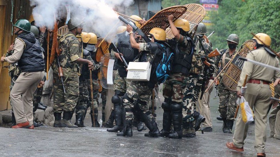 Indian security forces fire tear gas canisters during clashes with supporters of the separatist Gorkha Janmukti Morcha (GJM) group in Darjeeling on June 17, 2017.