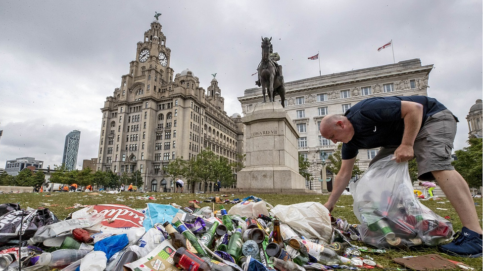 Man clears up rubbish outside Liver buildings