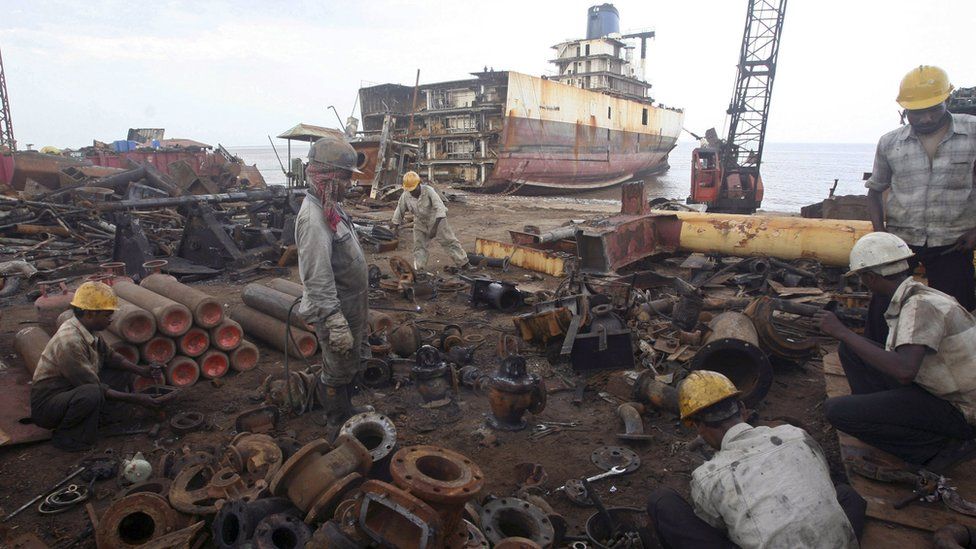 Workers dismantle a decommissioned ship at the Alang shipyard, 2007