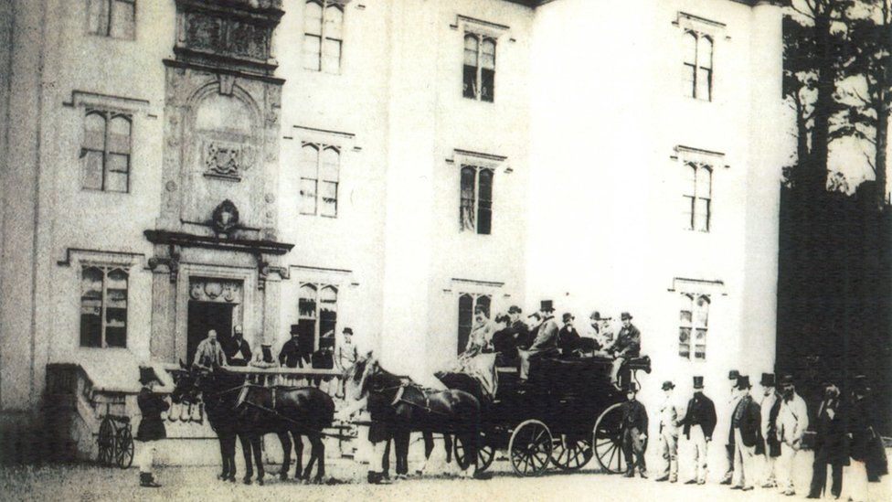 Black and white photograph of a horse-drawn coach party outside Antrim castle