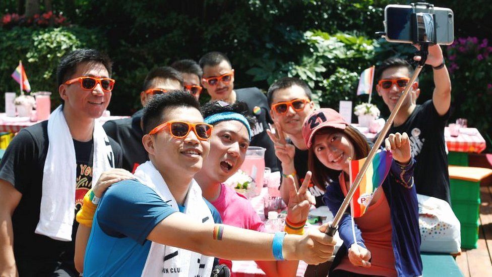 A group poses for photos after taking part in a Pride run in Shanghai in 2017.