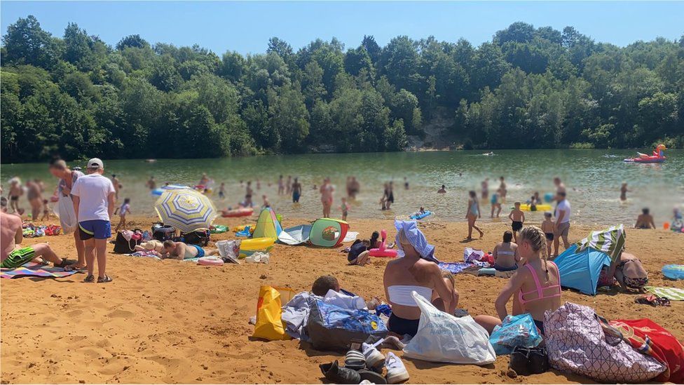 People in the water at Bawsey Pits at summer time