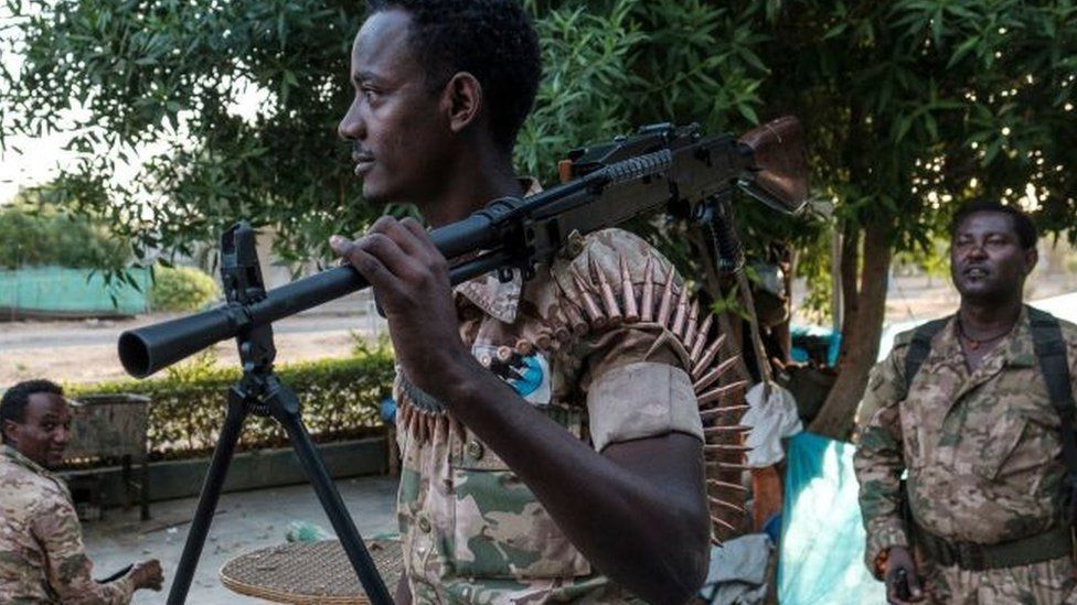 A member of the Amhara Special Forces holds a machine gun at an improvised camp in the front of a shop in Humera, Ethiopia, on November 22, 2020