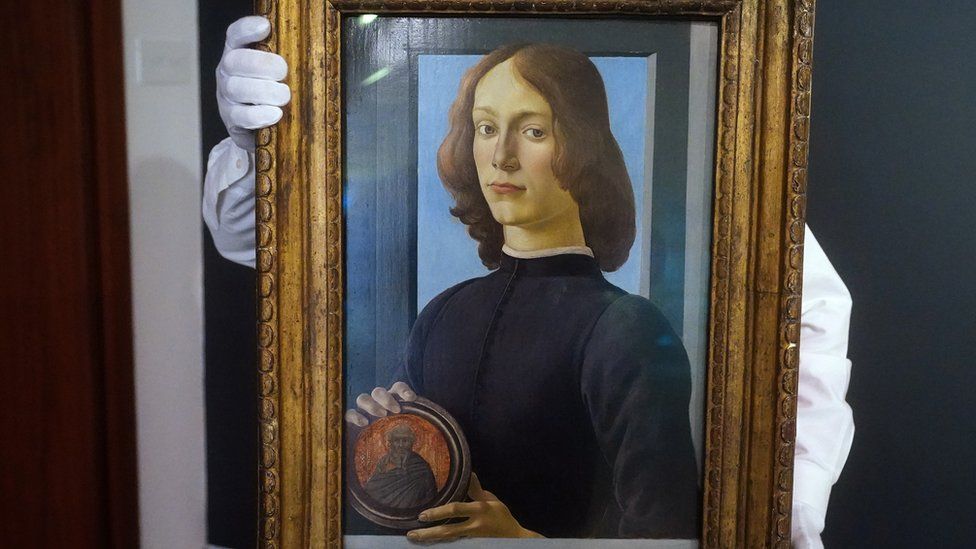 Young Man Holding a Roundel