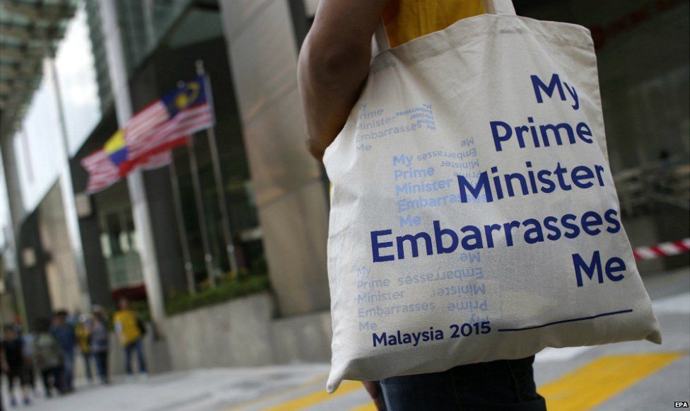 A Malaysian protestor carries a bag reading "My Prime Minister Embarrasses Me" as protesters gather in Kuala Lumpur - 29 August 2015