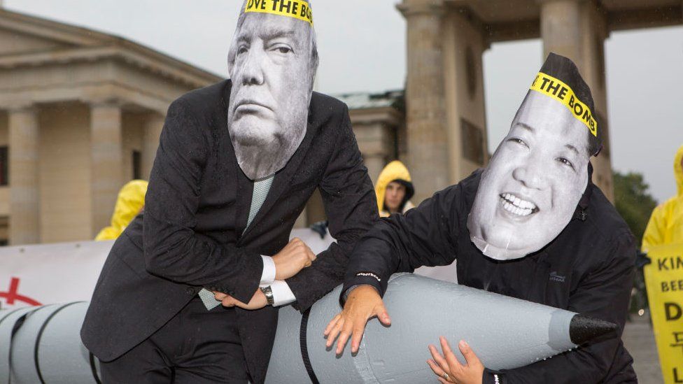 International campaign to abolish Nuclear Weapons (ICAN) activists wearing masks to look like US President Donald Trump and North Korean Kim Jong-Un pose next to a Styrofoam effigy of a nuclear bomb while protesting in front of the Brandenburg Gate near the American Embassy on September 13, 2017 in Berlin, Germany. The protests, which were organized by anti-nuclear and pro-peace group ICAN, took place at both the North Korean and US embassies.