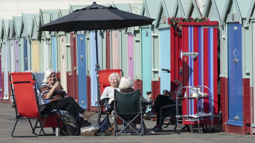 Members of the University of the Third Age iPhone photography group have an impromptu get together at beach huts in Hove, East Sussex