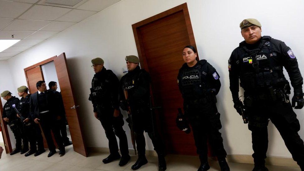 Police officers stand guard outside the courtroom during a hearing in the case of assassinated Ecuadorean presidential candidate Fernando Villavicencio, in Quito, Ecuador February 6, 2024.