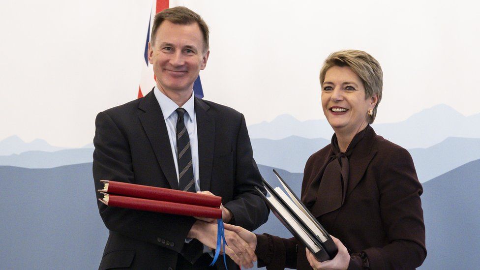 Britain's Chancellor of the Exchequer Jeremy Hunt (L) and Swiss Federal Councillor Karin Keller-Sutter (R) attend a press conference after signing of the agreement of mutual recognition in financial services for over two years between Switzerland and the United Kingdom
