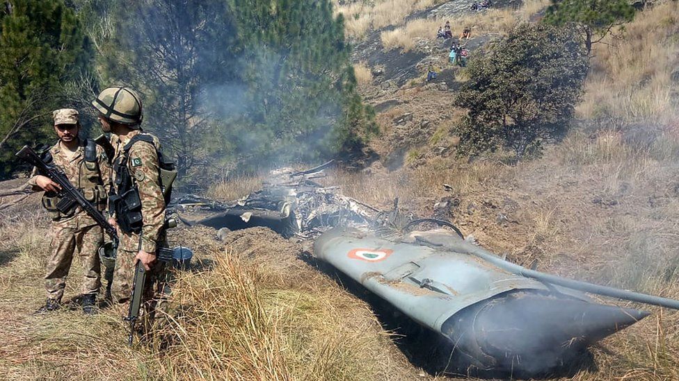Pakistani troops guard wreckage of an Indian plane, February 2019