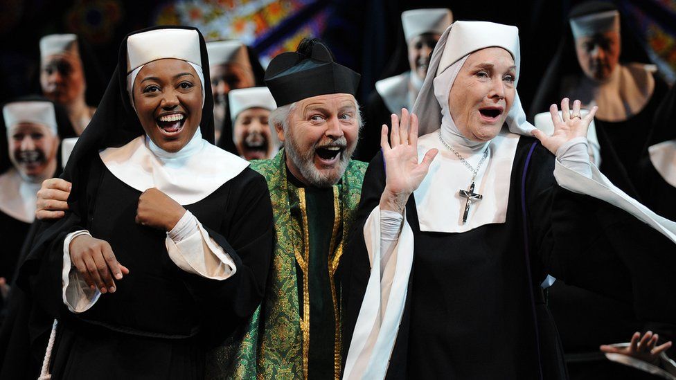 Ian Lavender with the cast of Sister Act: The Musical