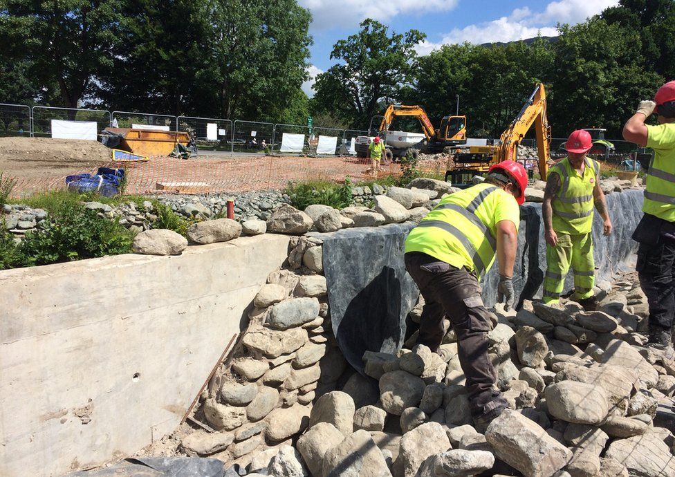 Workers construct a new river flood defence at Glenridding - disguised as a traditional dry stone wall.