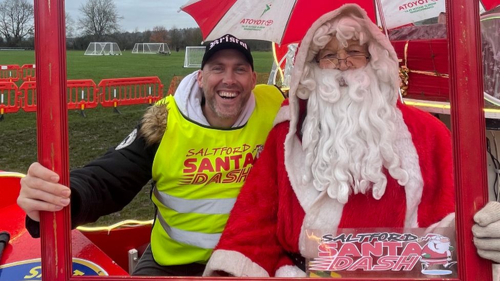 Joe Sims sitting next to Santa