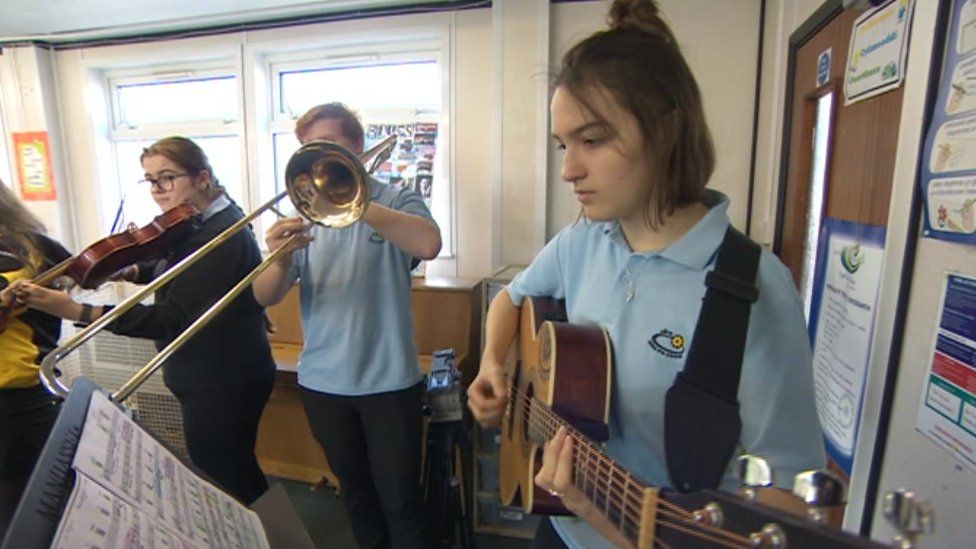 Pupils playing instruments in school