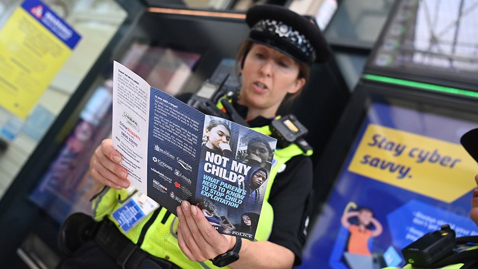 Police officer with leaflet