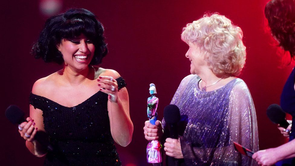 Raye on stage after winning the award for Song of the Year during the Brit Awards, with Jo Hamilton