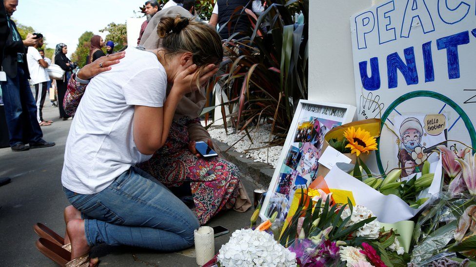 A woman reacts at a make shift memorial outside the Al-Noor mosque in Christchurch