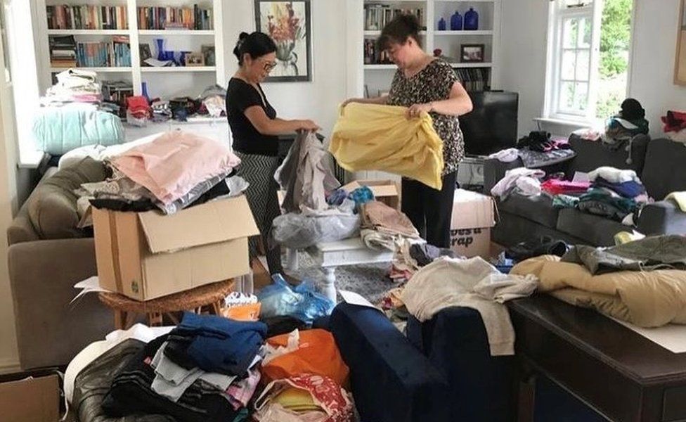 Two people in a room with materials meant to make reusable sanitary products