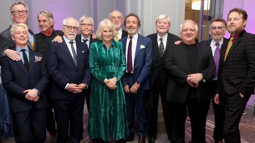 Left-right: Freddie Fox, Alex Jennings, Jeremy Irons, Brian Cox, Tom Courtenay, Queen Camilla, Peter Egan, Robert Lindsay, Martin Jarvis, Simon Russell Beale, Robert Powell and Samuel West.