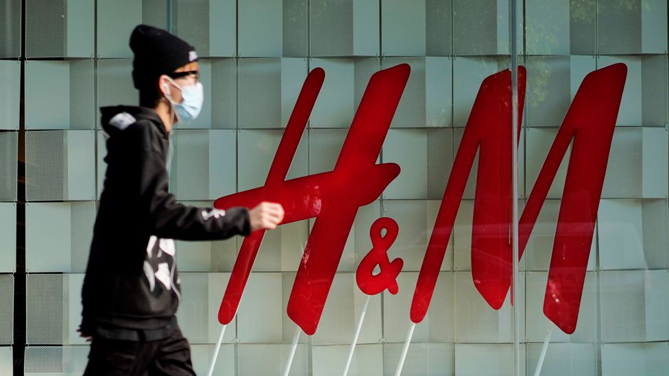 A person walks by an H&M store on 25 March 2021 in Kunming, Yunnan Province, China