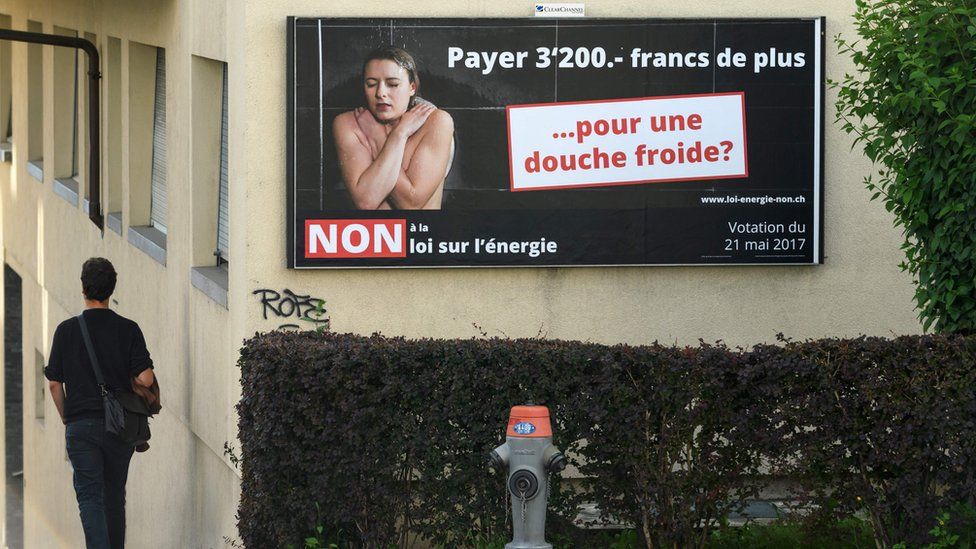 An electoral poster against a Swiss referendum on a new energy strategy reading in French: "Pay 3,200 francs more... for a cold shower?" seen on May 20, 2017 in Lausanne, western Switzerland