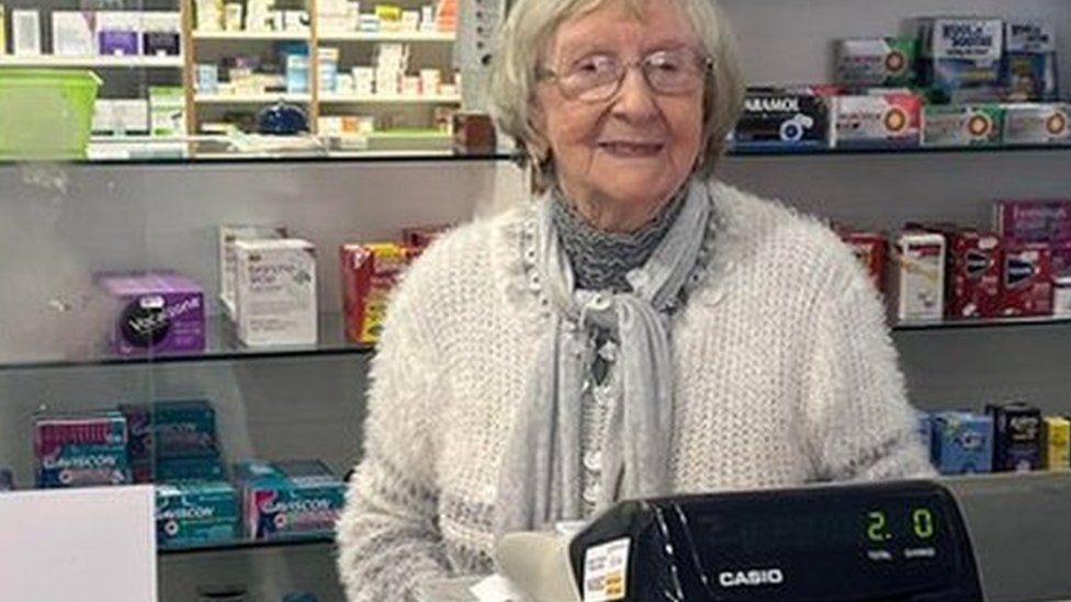 Betty Pritchard behind the till