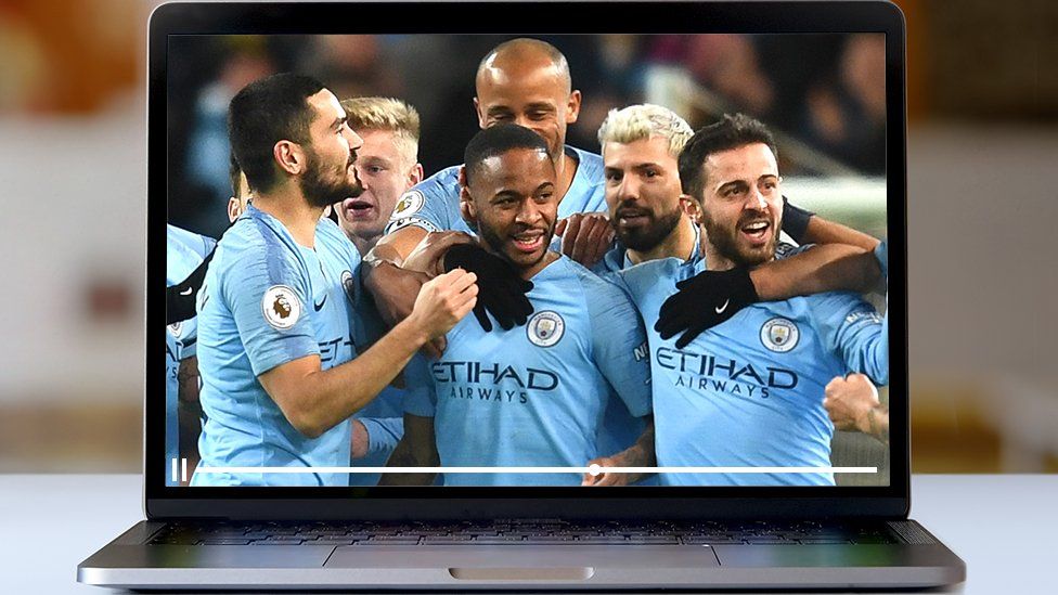 Man City players celebrate on a laptop