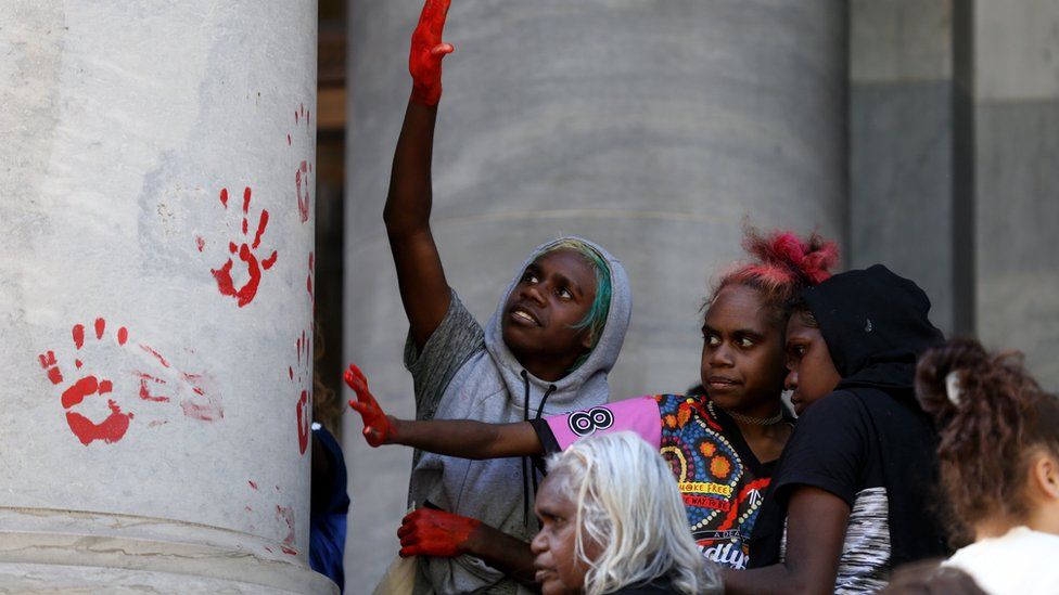 Protesters leave red handprints on the columns outside the South Australia Parliament on 13 November
