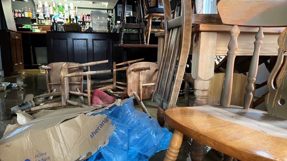 Furniture piled high in the Railway Inn pub to avoid flood water on the floor.
