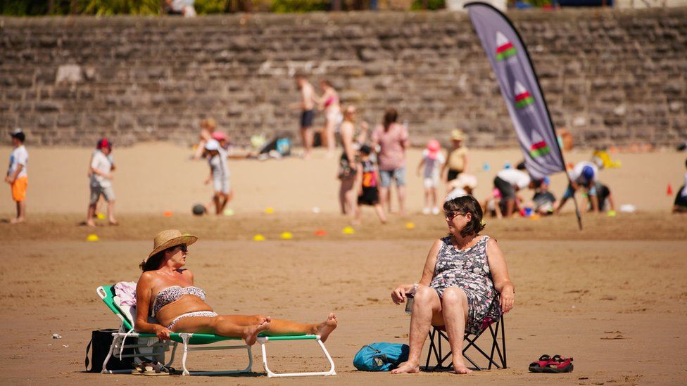 People are flocking to the beaches around the UK, like here at Barry Island in Wales