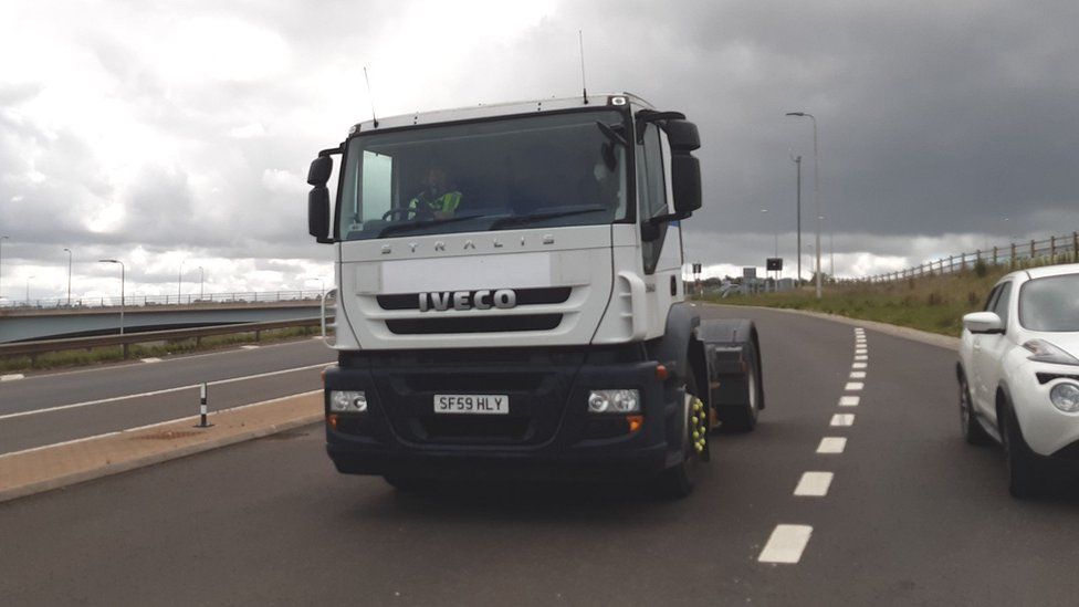 A police officer drives an unmarked HGV cab